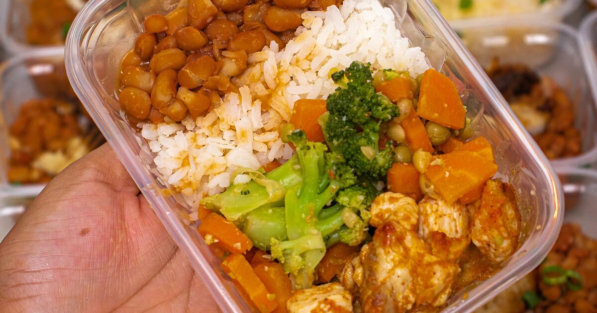 An Intestinal body type reset plate in a meal-prep container — white basmati rice, pinto beans, cooked broccoli, carrots, sweet potato, peas, and chicken
